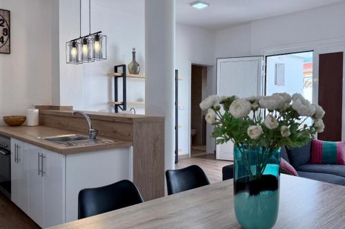a kitchen with a vase of flowers on a table at Casa en la montaña in Montana la Data