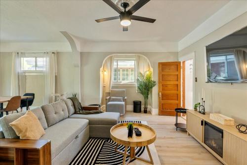 a living room with a couch and a table at Private HotTub GameRoom and Fenced Backyard in Ogden