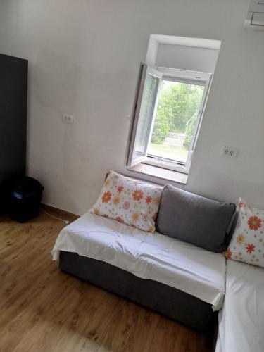 a couch sitting in a room with a window at Brine in Starigrad-Paklenica