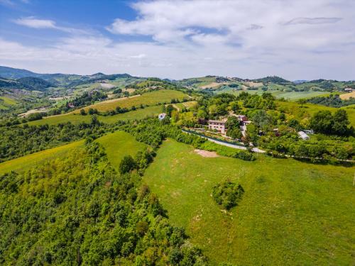 an aerial view of a house in a green field at Residenza Storica sulle Colline di Maranello in Fogliano