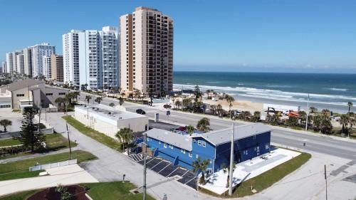 a view of a beach with buildings and the ocean at Blue Mist Motel - Room #4 in Daytona Beach