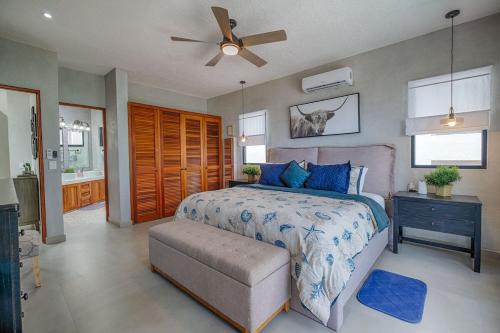 a bedroom with a bed and a ceiling fan at Breeze House - Paradise awaits in Akumal