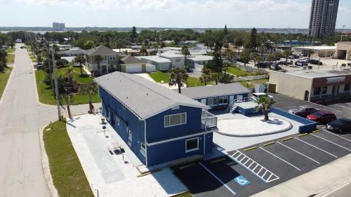 an aerial view of a blue building with a parking lot at Modern King Suite #12 - Steps to Beach in Daytona Beach