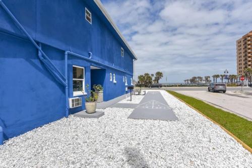 a blue building with gravel next to a street at Modern King Suite #12 - Steps to Beach in Daytona Beach