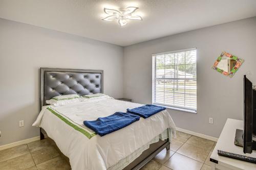 a bedroom with a large bed and a window at Pet-Friendly Palm Coast Home 8 Mi to Beach! in Palm Coast