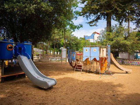 a playground with a slide in a park at Joli Mobilhome 6P Camping Bois Dormant in Saint-Jean-de-Monts