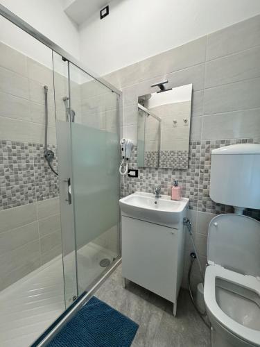 a bathroom with a shower and a toilet and a sink at Casa Duca D'aosta in Mestre