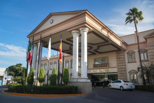 a hotel with flags in front of a building at Royal Palace in Hermosillo
