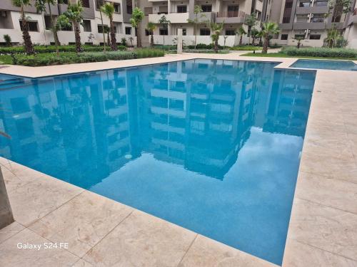 a swimming pool in front of a building at aeroperla 11 aeroprt casa blanca in Nouaseur