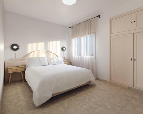 A bed or beds in a room at Apartamentos Princesa Guayadeque