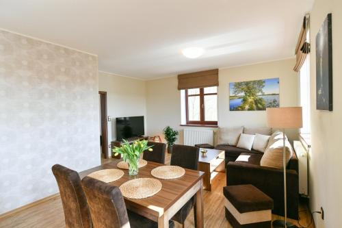 a living room with a table and a couch at Apartmány Na Seníku in Třeboň