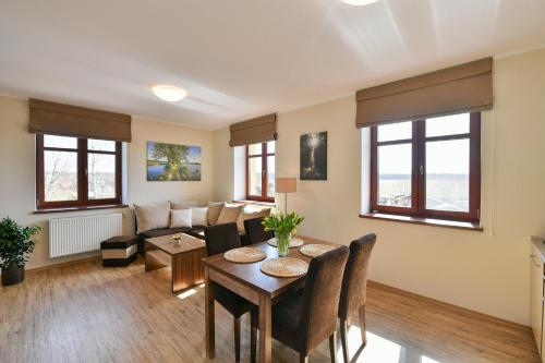 a living room with a table and a couch at Apartmány Na Seníku in Třeboň