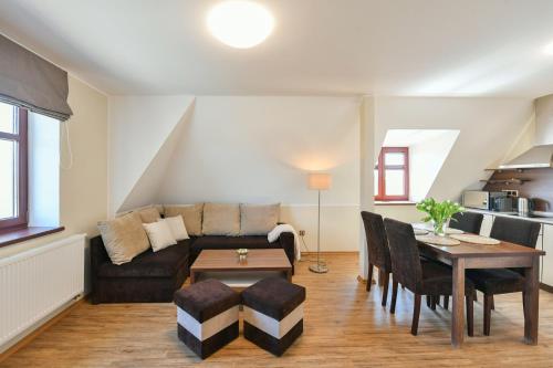 a living room with a couch and a table at Apartmány Na Seníku in Třeboň