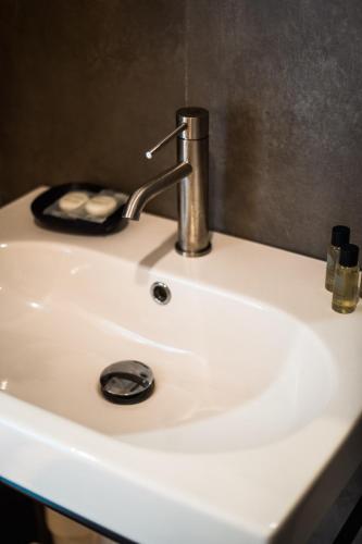 a sink with a faucet on top of it at Whisky Green Coast Hotel & Apartments in Palasë