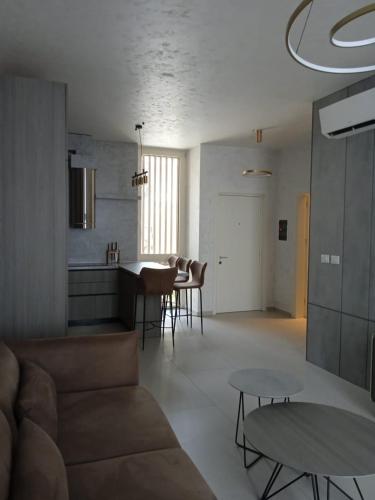 a living room with a couch and a table at Whisky Green Coast Hotel & Apartments in Palasë