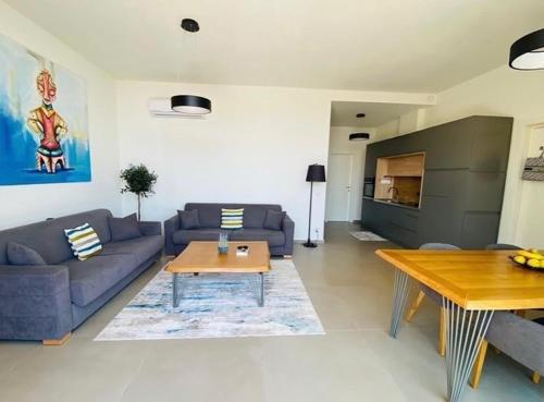 a living room with a couch and a table at Whisky Green Coast Hotel & Apartments in Palasë