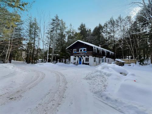 a house on a road covered in snow at BearHaus Central AC, HUGE Hot Tub, Awesome FirePit in Killington