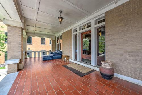 a porch of a house with a couch and a vase at The Uptown Suite at The Historic Connely Harrington in Siloam Springs