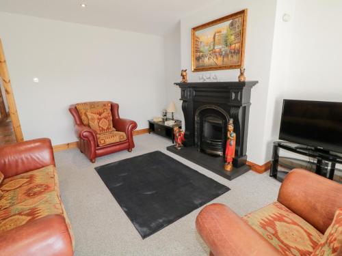 a living room filled with furniture and a fireplace at SeaShells in Coleraine