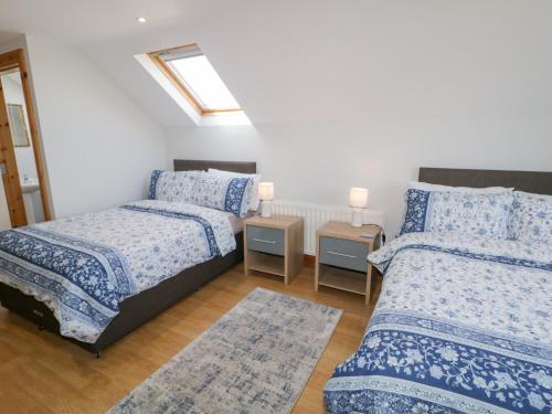 a bedroom with two beds and a window at SeaShells in Coleraine
