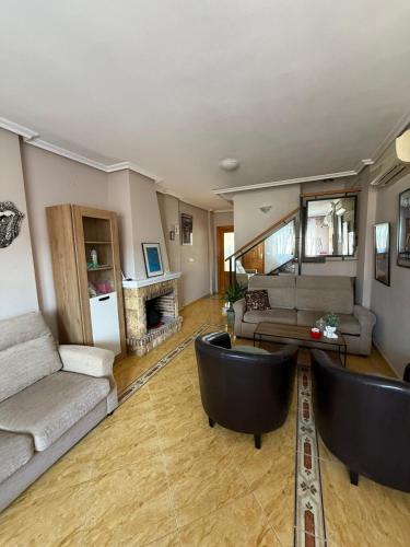 a living room with a couch and a table at Amanecer en la Costa in Villamartin
