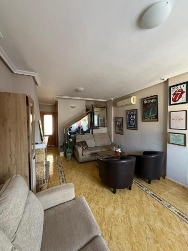 a living room with a couch and a table at Amanecer en la Costa in Villamartin