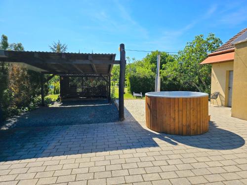 a wooden barrel sitting in the middle of a patio at Nr 25 Ferienhaus Astor in Keszthely