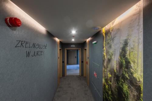 a hallway with writing on the walls of a building at Przystań Marywil in Żarki