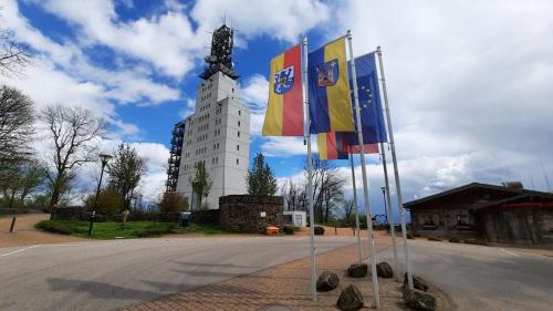 a tall building with flags in front of it at Haus Glücksmomente Bostalsee in Nohfelden