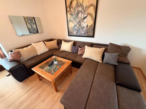 a living room with a couch and a coffee table at Haus Glücksmomente Bostalsee in Nohfelden