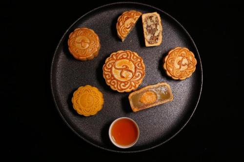 a plate of cookies and bread and dipping sauce at Kempinski Hotel Shenzhen - 24 Hours Stay Privilege, Subject to Hotel Inventory in Shenzhen