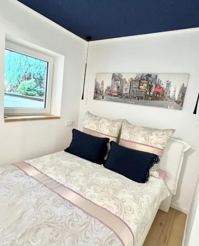 a small bedroom with a bed and a window at Scandi Apartment with Terrace and Parking in Karlsruhe