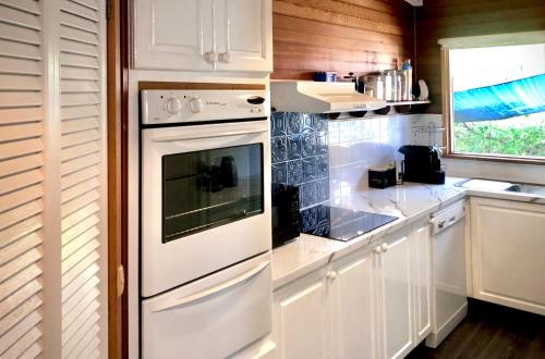 a kitchen with white cabinets and an oven at Anchorage Cottage Ventnor, Phillip Island - pet friendly, free WiFi, linen included in Ventnor