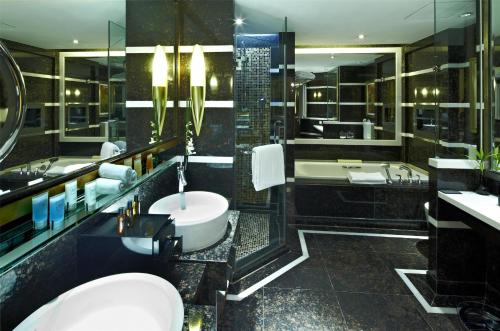 a bathroom with a tub and a toilet and a sink at Kempinski Hotel Shenzhen - 24 Hours Stay Privilege, Subject to Hotel Inventory in Shenzhen