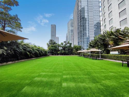 a green lawn in the middle of a city at Kempinski Hotel Shenzhen - 24 Hours Stay Privilege, Subject to Hotel Inventory in Shenzhen