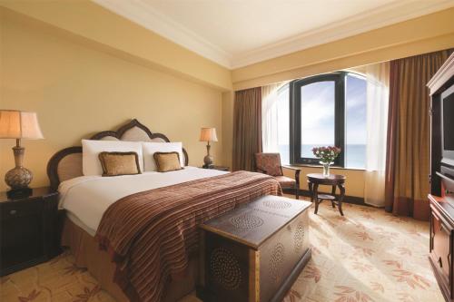 a hotel room with a large bed and a window at Djibouti Palace Kempinski in Djibouti