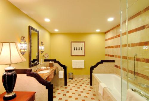 a bathroom with a tub and a sink at Djibouti Palace Kempinski in Djibouti