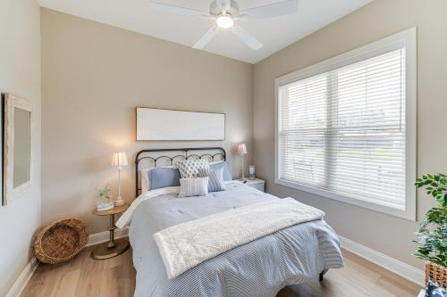 a bedroom with a bed and a window at Walk to Lake Erie Sleek Retreat with Screened Patio in Madison