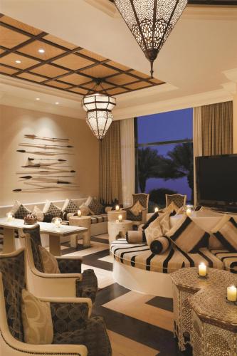 a living room with couches and a flat screen tv at Djibouti Palace Kempinski in Djibouti