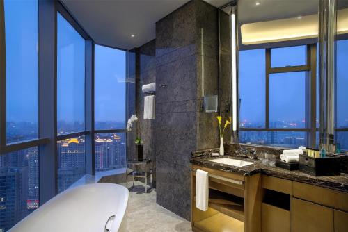 a bathroom with a tub and a large window at Kempinski Hotel Changsha in Changsha