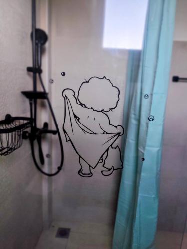 a bathroom with a cartoon whale on the wall at Villa DAMAKI in Kriopigi