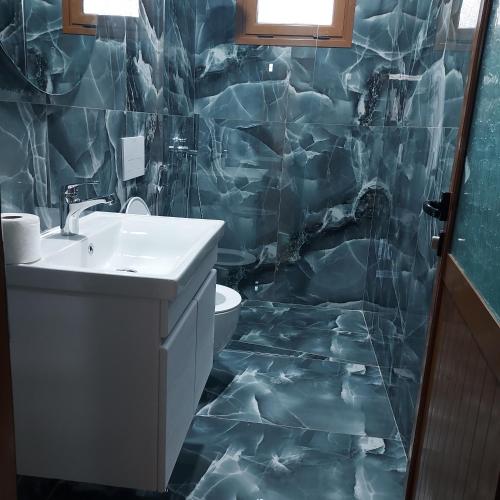 a bathroom with a sink and a toilet in it at Vila Martini in Vlorë