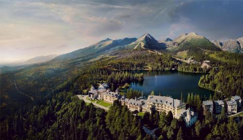 an aerial view of a castle in the middle of a lake at Grand Hotel Kempinski High Tatras in Štrbské Pleso