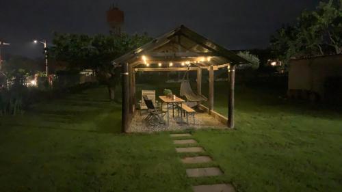 a gazebo with a table and chairs in a yard at night at BB Borgo Biella in Candelo