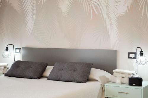a bedroom with a white bed with two pillows at B&B Borgo Sabelli - Costa dei Trabocchi in Casalbordino