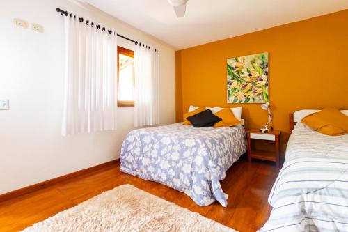 a bedroom with two beds and a window at Putini Pousada e Hotel by OYO in São Roque