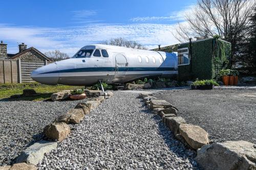 a blue and white airplane parked in a driveway at Alaya Airways in Dolgellau