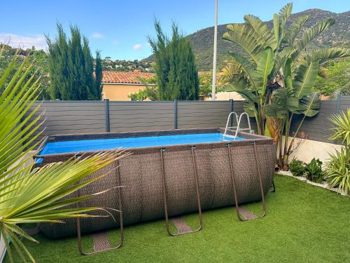 une piscine avec une balançoire dans un jardin dans l'établissement Villa strelitzia, à Cavalaire-sur-Mer