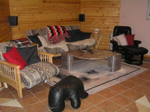 a living room with a couch and a table at End of the road B & B in Cranbrook