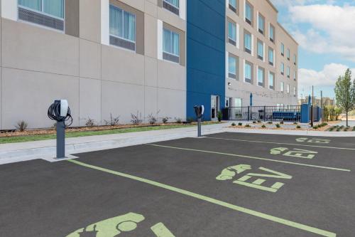 a parking lot with two parking meters in front of a building at Hampton Inn & Suites by Hilton Little Rock Airport in Little Rock